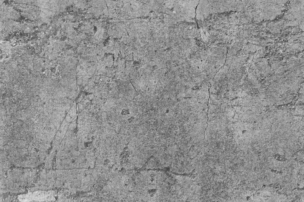 Cracked gray concrete wall with rough texture and visible lines.